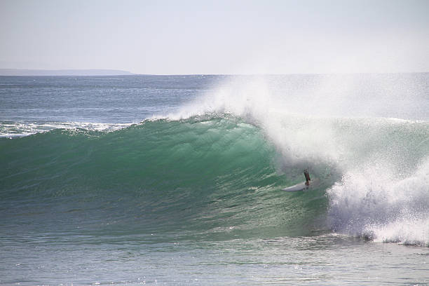 Surfer tube riding stock photo