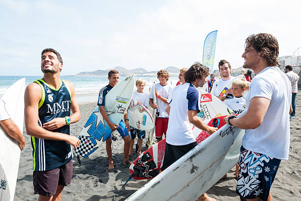 Surfers showing their support F.C. Barcelona and Real Madrid Las Palmas, Spain - August 29, 2012: Unidentified young surfers from University Surf School and Surf Camp Las Palmas during a informal competition, formed as an football match with 11 surfers in each team, one team is wearing uniforms from football club F.C. Barcelona, the other one is Real Madrid. fc barcelona stock pictures, royalty-free photos & images