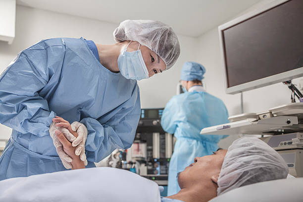 Surgeon consulting a patient, holding hands, getting ready for surgery stock photo