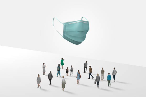 Surgical Mask Floating In White Space Above Crowd Of Mini Figurines stock photo