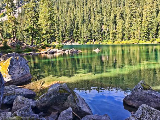 Surprise Lake Light and shadow play on the surface of the North Cascades' Surprise Lake in late late summer. alpine lakes wilderness stock pictures, royalty-free photos & images