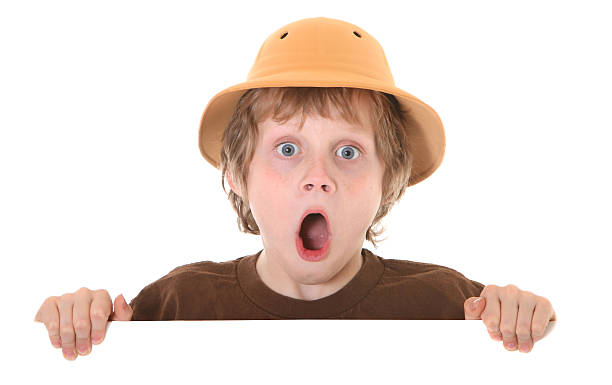 surprised boy with pith helmet stock photo