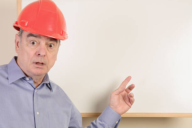 Surprised construction guy presenter stock photo