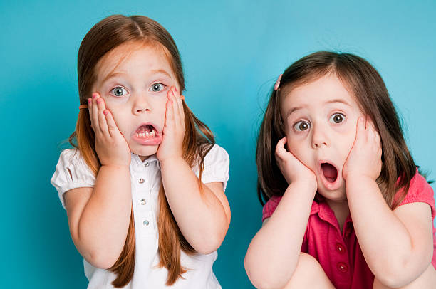 Surprised Little Girls with Looks of Shock stock photo