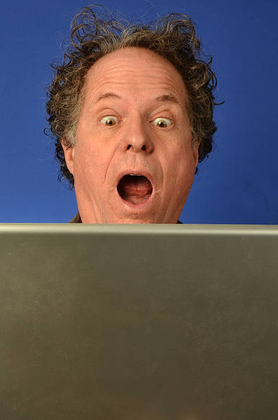 Man with a surprised look while working on his computer.