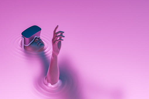surrealistic scene of a girl with VR glasses immersed in liquid with neon lighting. metaverse concept, nft, creative art and technology. 3d rendering. fictional character