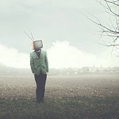 man walking on field with television on his head
