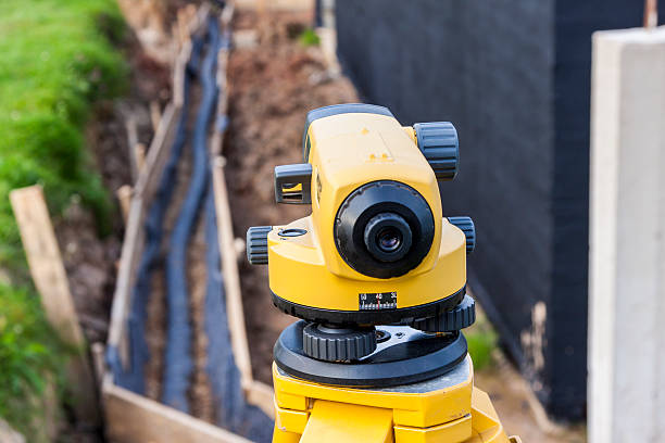 Surveyor equipment optical level at construction site stock photo