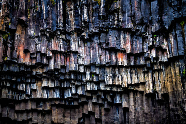 Svartifoss waterfall closeup of basalt rocks pattern in Skaftafell national park in Iceland cliff wall Svartifoss waterfall closeup of basalt rocks pattern in Skaftafell national park in Iceland cliff wall basalt stock pictures, royalty-free photos & images