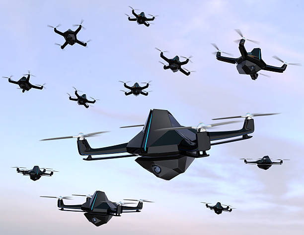 Swarm of drones flying in the sky stock photo