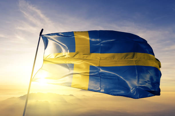 sverige svenska flagga textil tyg viftar på den översta sunrise dimma dimman - swedish flag bildbanksfoton och bilder
