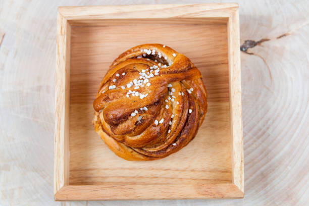 Swedish cinnamon bun on wood stock photo