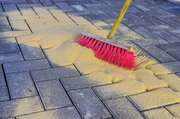Sweeping in joint sand on a construction site stock photo
