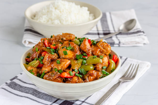 Sweet and Sour Chicken in a Bowl with Rice stock photo