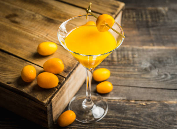 Sweet cocktail with kumquats on rustic background Sweet cocktail with kumquats on rustic background. Selective focus. Shallow depth of field. kumquat stock pictures, royalty-free photos & images