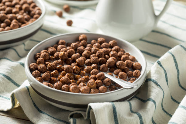 Sweet Cocoa Chocolate Sugar Cereal Puffs Sweet Cocoa Chocolate Sugar Cereal Puffs with Milk breakfast cereal stock pictures, royalty-free photos & images