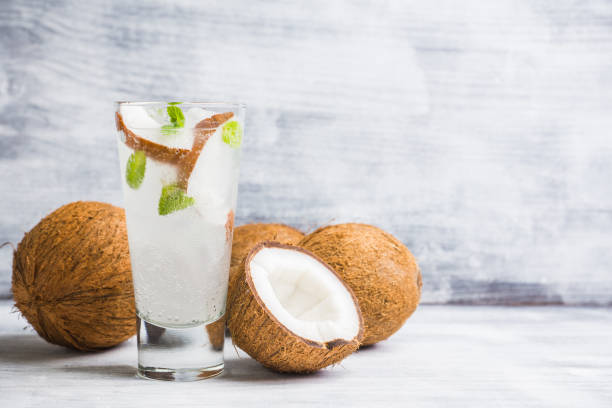 Sweet coconut mojito cocktail on the wooden background stock photo