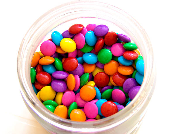 Sweet Colorful Colorful sweet with chocolate filling. In Brazil it's called "confetti".  candy jar stock pictures, royalty-free photos & images