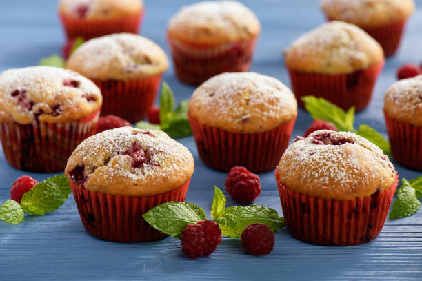 Sweet homemade raspberry muffins on wooden table. stock photo