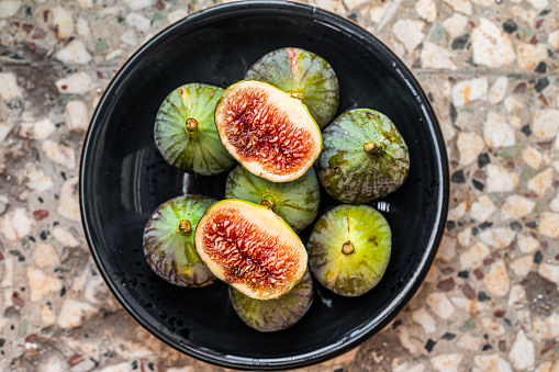 Sweet Organic Green Figs on a plate. Top view. Gray background.