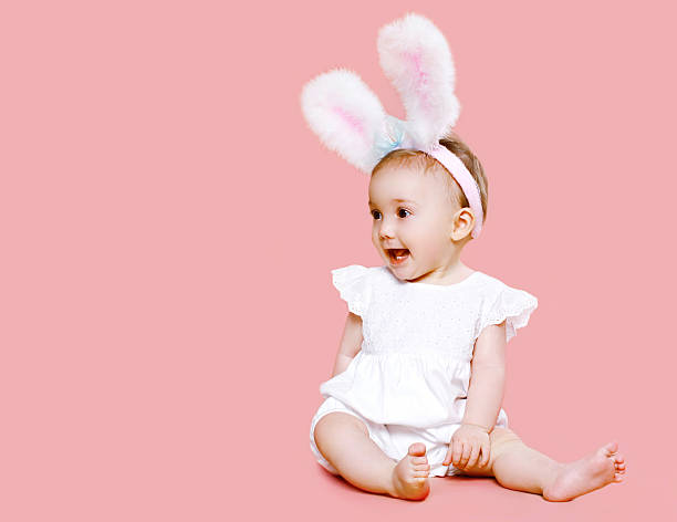 Sweet pink cute baby in costume easter bunny stock photo