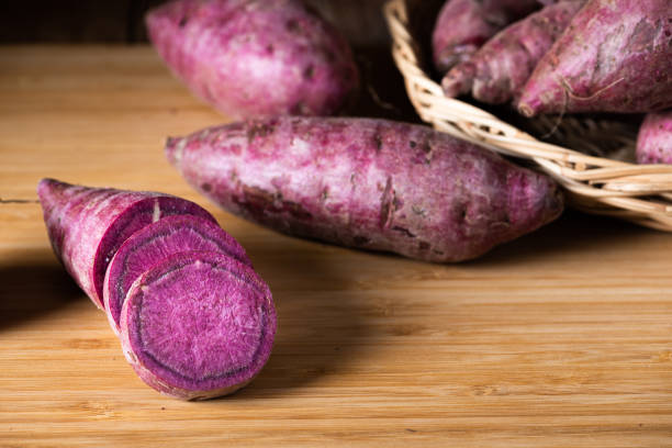 Sweet Potatoes Purple Colored on Table stock photo