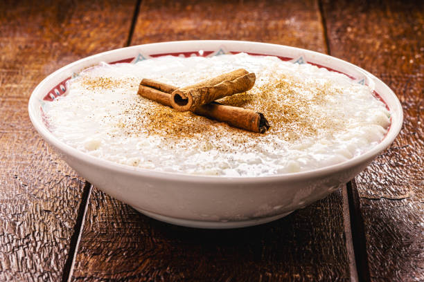 sweet rice pudding, with cinnamon stick and cinnamon powder, homemade dessert, close up and copyspace stock photo