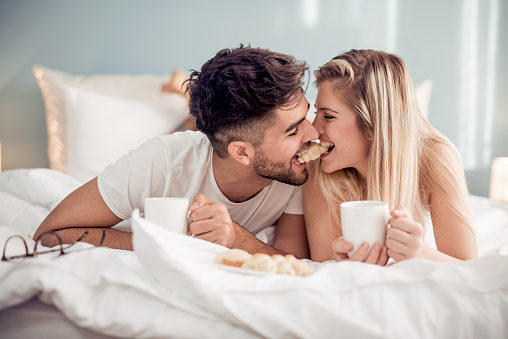 Sweet Young Couple Lying In The Bed In Bedroom Stock Photo - Download Image  Now - iStock