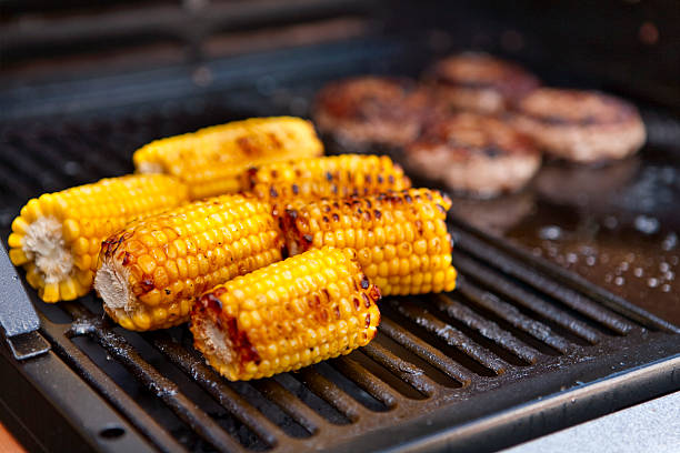 Sweetcorn cooking on a barbecue stock photo