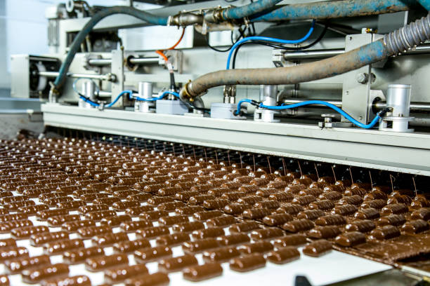 Sweets factory. Sweets production process. Conveyor belt with sweets on it. stock photo