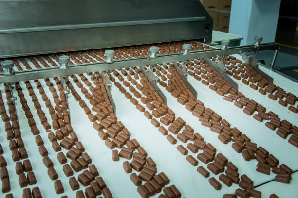 Sweets factory. Sweets production process. Conveyor belt with sweets on it. stock photo