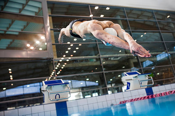 Swimmer jumping stock photo