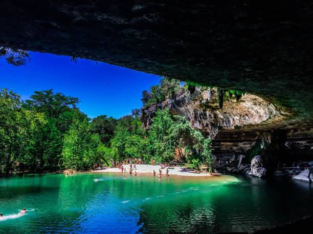 Swimmers at Hamilton Pool Hamilton Pool, located in the Hill Country outside of Austin Texas. May 2017 nature reserve stock pictures, royalty-free photos & images