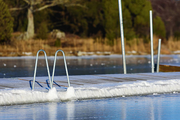 swimming dock in winter - ice bath in natural frozen lake bildbanksfoton och bilder