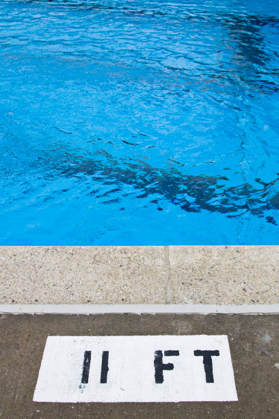 Swimming pool depth 11 feet Poolside depth marker at deep end of swimming pool. number 11 stock pictures, royalty-free photos & images