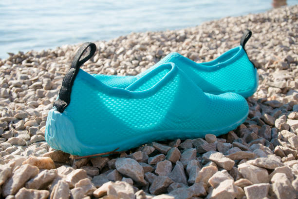 Swimming shoes on beach stock photo