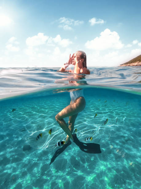 Swimming with fish in the sea Swimming with fish in the sea woman snorkeling stock pictures, royalty-free photos & images