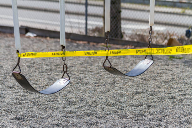 COVID Swing Set A set of swings are caution taped off during COVID-19 prevention measures. recess stock pictures, royalty-free photos & images