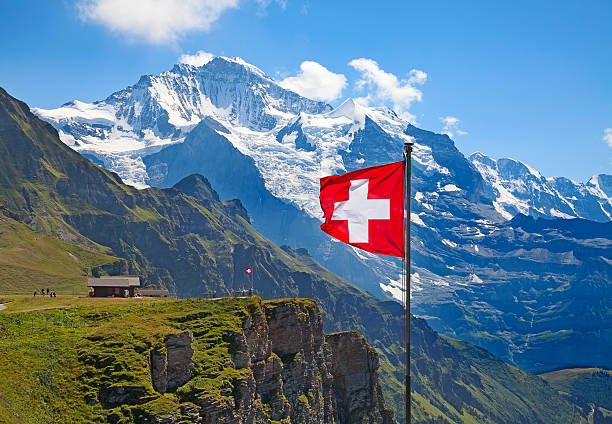Swiss flag Swiss flag on the top of Mannlichen (Jungfrau region, Bern, Switzerland) valais canton stock pictures, royalty-free photos & images