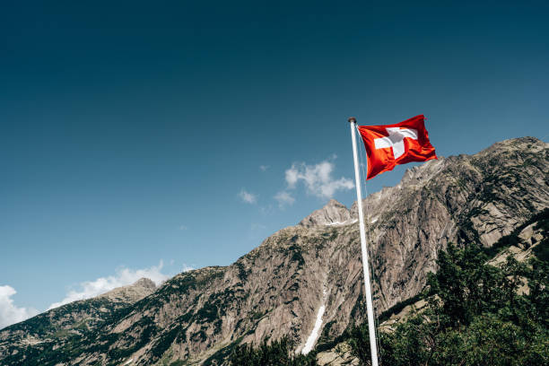 switzerland flag waving on the sky stock photo