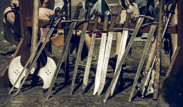 Swords set up in a row for the knight demonstration at a medieval market stock photo