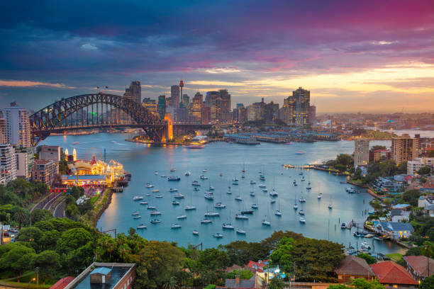 Sydney. Cityscape image of Sydney, Australia with Harbour Bridge and Sydney skyline during sunset. international landmark stock pictures, royalty-free photos & images