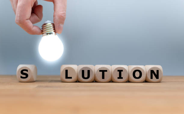 A Symbol for finding a solution. Dice and a light bulb form the word "SOLUTION". stock photo