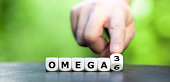 istock Symbol for healthy food. Hand turns dice and changes the expression "Omega 6" to "Omega 3". 1342287725