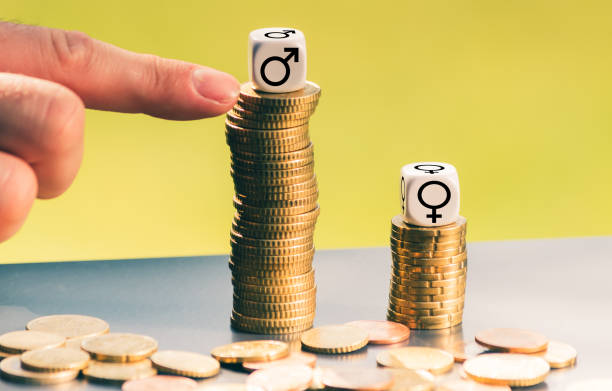 Symbol for unequal payment. Gender symbols on different high stacks of coins. stock photo