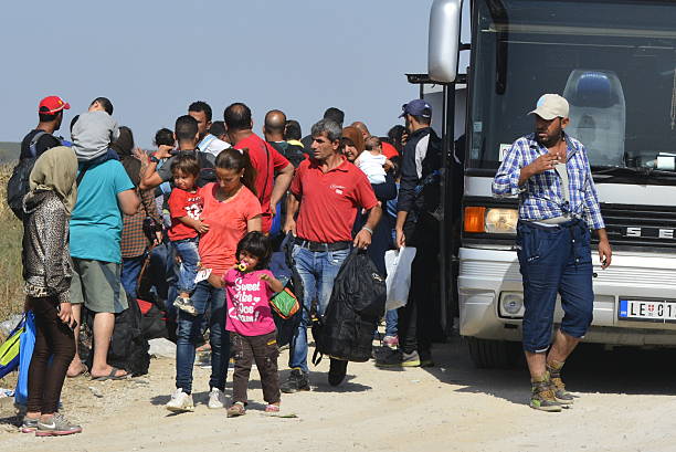 Syrian refugees on their way to EU, Serbia-Croatia Sid, Serbia - September 18th, 2015: Syrian refugees getting off the bus and goin from Serbia towards Croatia, on theri way to European Union. Photographed at the bordere Serbia-Croatia, refugees goint toward Tovarnik hot middle eastern women stock pictures, royalty-free photos & images