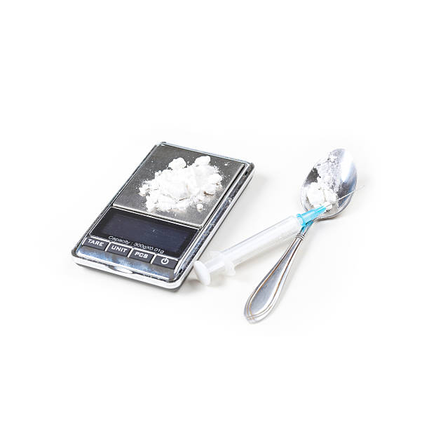 Syringe and digital scales with drugs Syringe and digital scales with drugs closeup on white mephedrone stock pictures, royalty-free photos & images