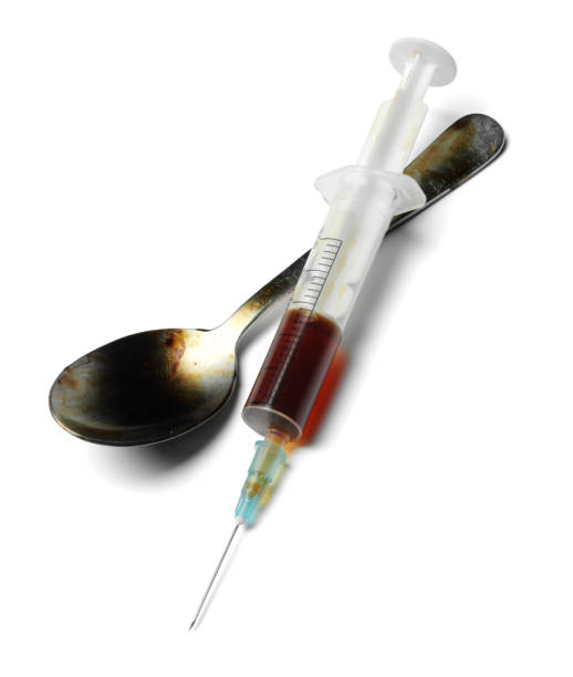 Syringe and Spoon Syringe and heroin, isolated on white with clipping path. heroin stock pictures, royalty-free photos & images