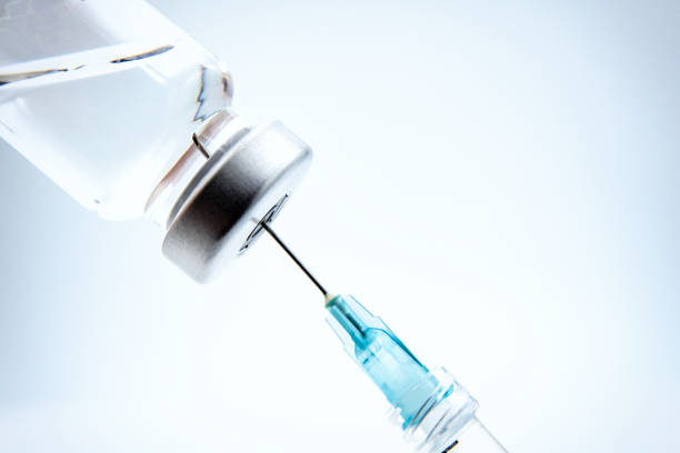 Syringe and Vial A medical vial of vaccine with a syringe arranged in studio against a white background. generic drug stock pictures, royalty-free photos & images