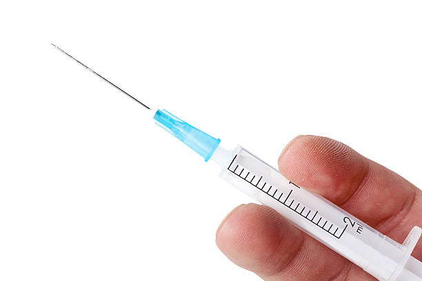 Syringe in hand Syringe in hand, closeup on white mephedrone stock pictures, royalty-free photos & images